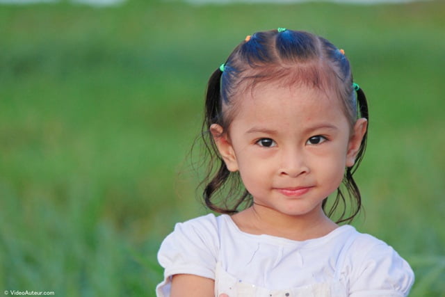 The face of a child photographed at 135 millimeters focal length.