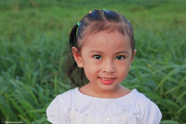 The face of a child photographed at 50 millimeters focal length.