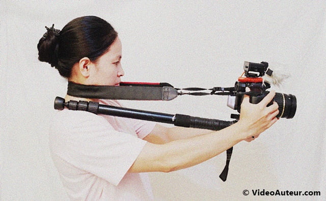 A lady shooter using a monopod and a camera strap as shoulder rig.