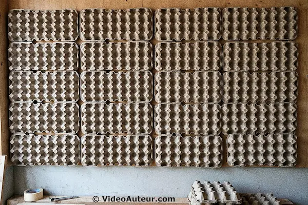 n image showing egg cartons on a wall to serve as insulation in order to absorb sound. n image showing egg cartons on a wall to serve as insulation in order to absorb sound.