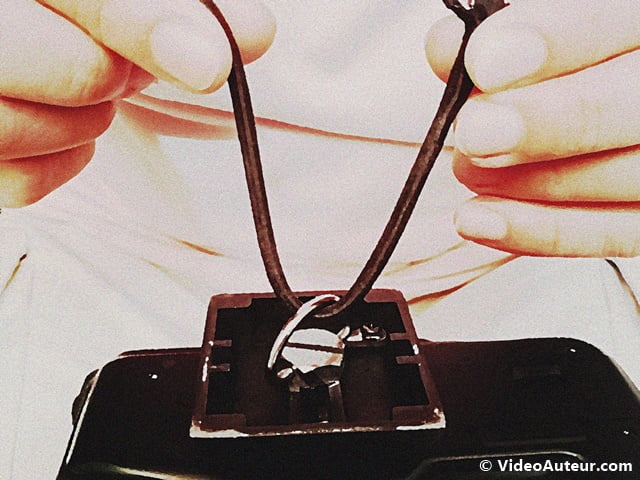 Inserting the garter string into the ring of a tripod plate screw.