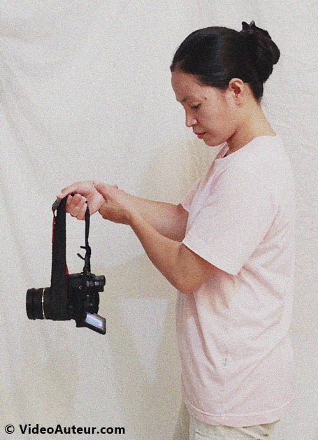 Hanging your camera and lens on the strap as DIY camera stabilizer.